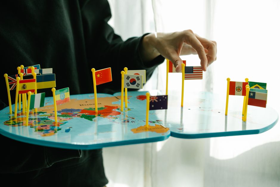 image of a person looking at a world map with flags of the USA and another country (e.g., Mexico) pinned on it - dual citizenship lawyer near me