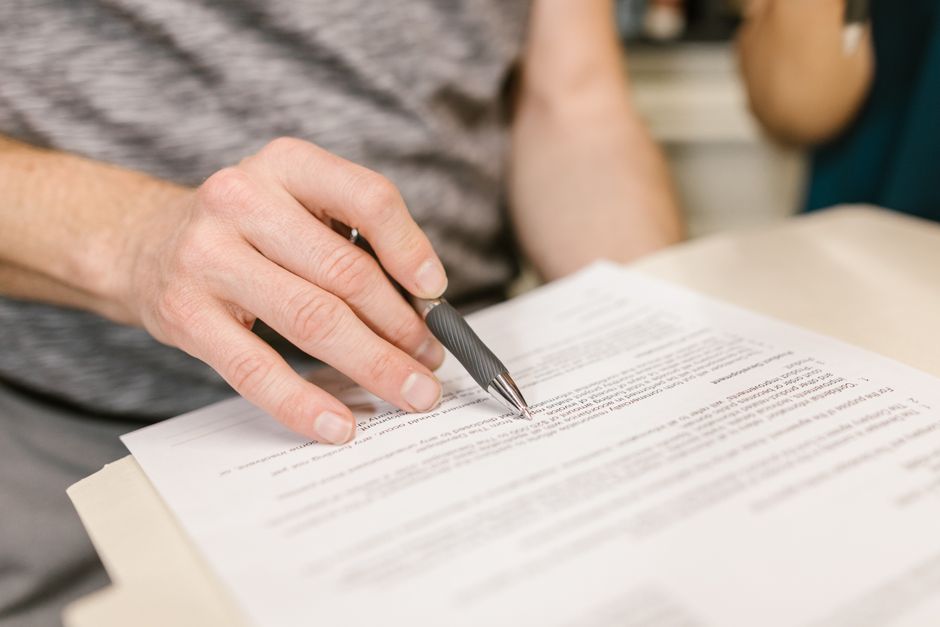 A person diligently filling out an official government form, emphasizing the detailed nature of the application process. - Humanitarian parole lawyer