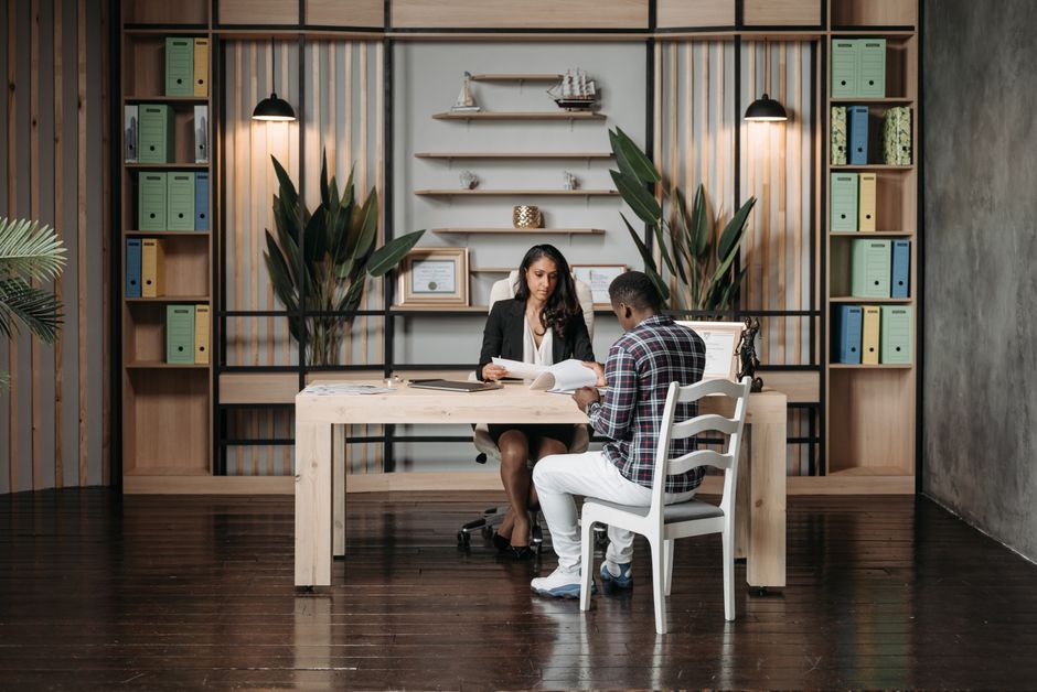 An attorney and client in a consultation, discussing legal documents - immigration attorney for deportation
