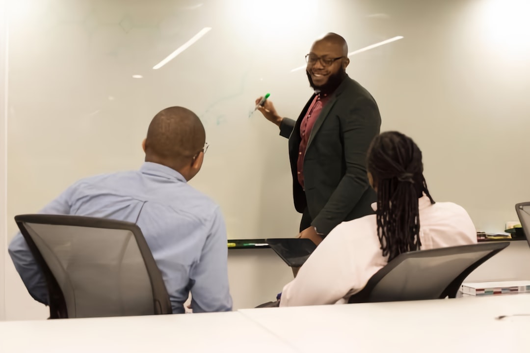 A manager leading a team meeting - L-1 visa attorney